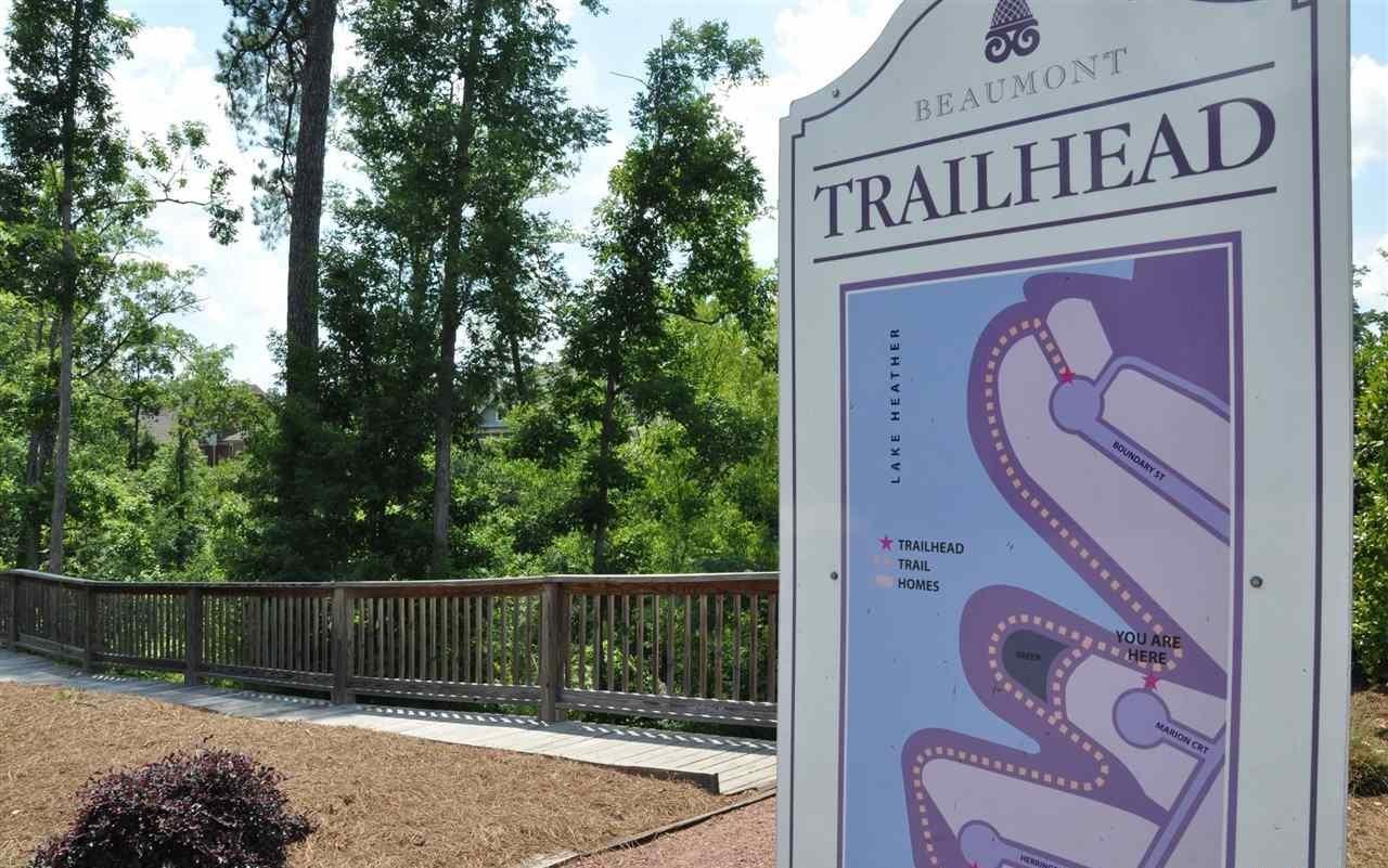 Beaumont trailhead sign beside a wooded walking trail